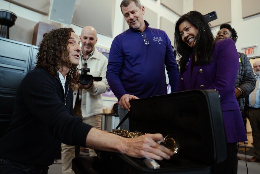 Grammy Award-winning saxophonist Kenny “G” Gorelick signs a soprano saxophone won at an auction fundraiser by Tim and Christina Schellhardt on Wednesday, Dec. 3, 2025, at Christian Brothers College High School in Town and Country. Gorelick first befriended a member of the school’s board, not pictured, more than two decades ago after the two bonded over their BlackBerry phones on a flight.