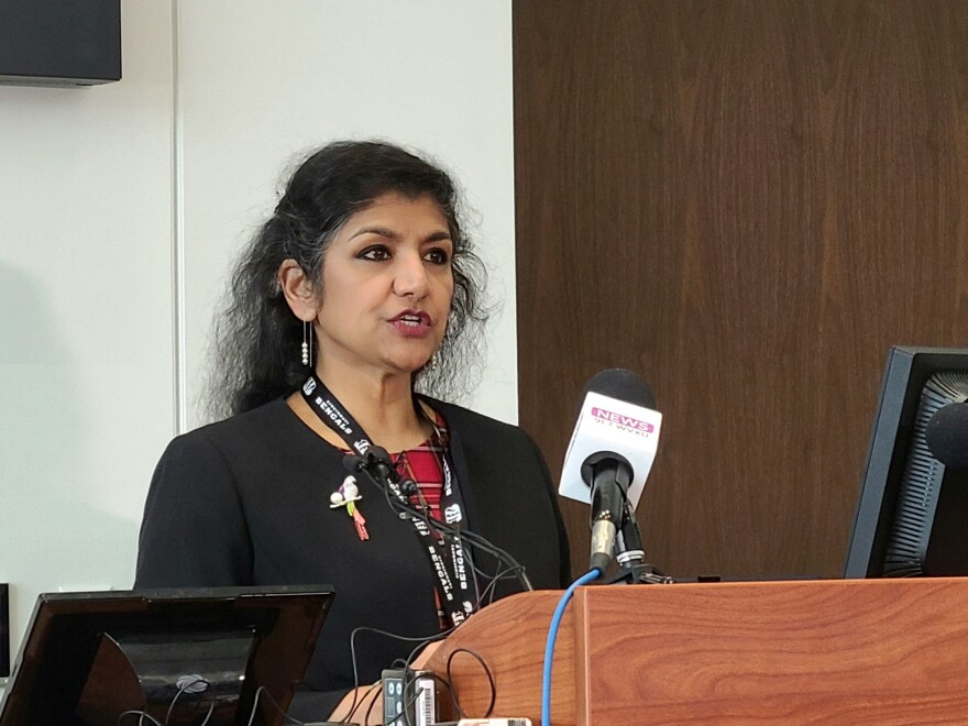 woman speaks at a podium