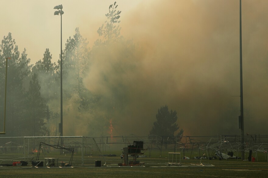 Old Trails Fire burns near Dwight Merkel Sports Complex, Saturday, Aug. 1, 2026, in Spokane, Wash. (AP Photo/Young Kwak)