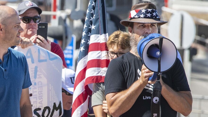 Alan Hostetter, seen here in May 2020, became a leading activist against coronavirus-related lockdown policies in Orange County, Calif. Hostetter, a former police chief and yoga instructor, was convicted of conspiring to obstruct congress' certification of the 2020 presidential election results at the Jan. 6, 2021, riot at the U.S. Capitol.