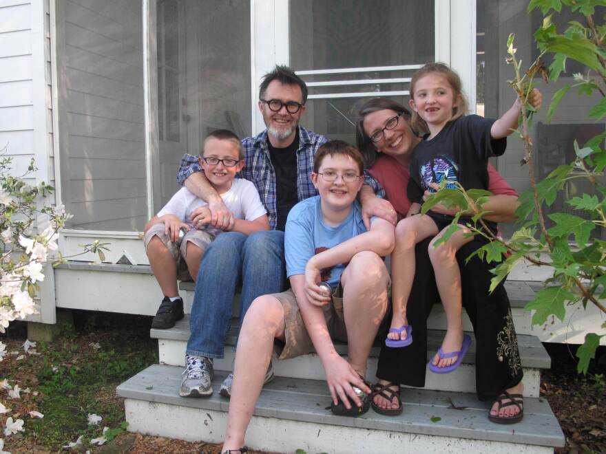 The Drehers — Lucas (from left), Rod, Matthew, Julie and Nora — sit on the side stoop at their new home in St. Francisville, La.