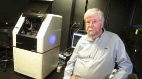 Paul Kincade, research vice president at the Oklahoma Medical Research Foundation, sits next to a new laser microscope in Oklahoma City.