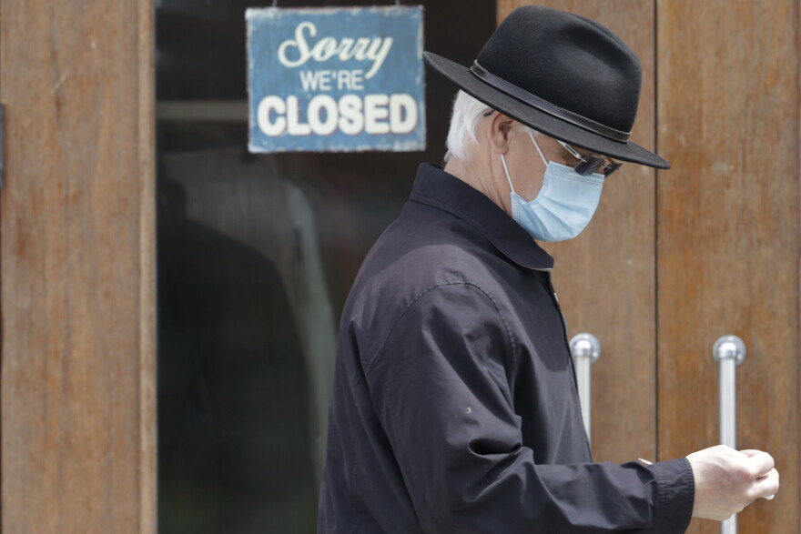 A man walks past a closed business in Shaker Heights, Ohio, on April 29.