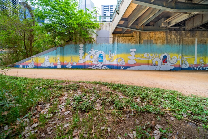 Seth Prestwood's Passages underneath the Drake Bridge depicts Austinites running, biking and paddleboarding on Lady Bird Lake.