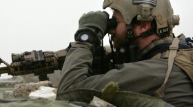 A U.S. Navy Seal looks towards insurgent movements from an observation post in the Anbar province of Iraq. Targeted killings and precision missiles are becoming more widely used in combat.