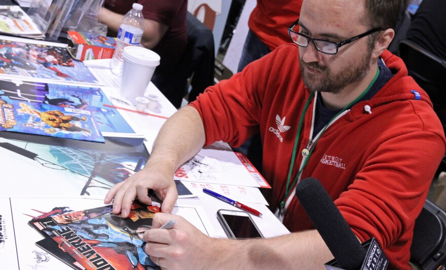 Marvel Comics artist Ryan Stegman (Troy, Michigan), signs an autograph at the 2016 Motor City Comic Con