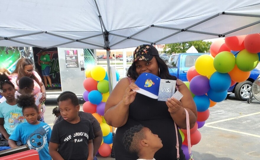 Families line up for backpacks and school supplies at the annual Backpack Giveaway organized by Touch of Perfection and partners.