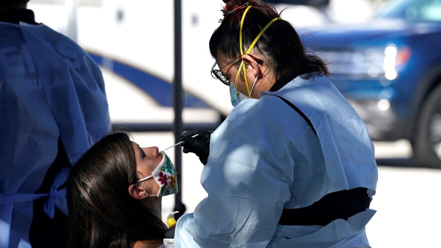 A child gets tested for COVID-19.