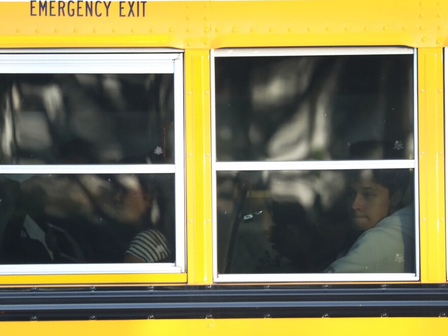 Students on a school bus arrive for the first day of classes.