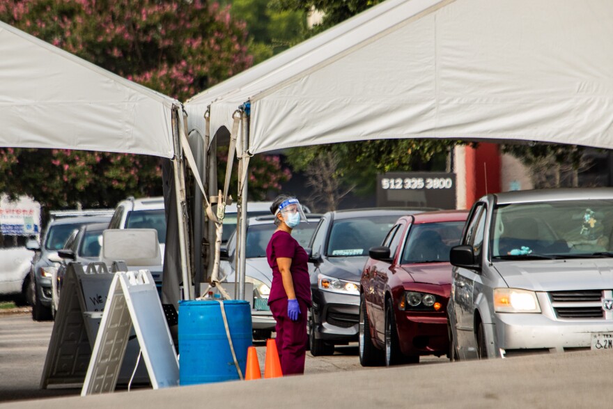 Cars line up for CommUnityCare's drive-thru COVID-19 testing at Hancock Center.