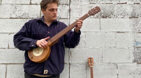 Bradford Harris plays an old-time tune in the backyard of their Harlan, Kentucky home. Harris built the banjo with his dad. 