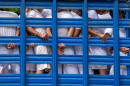 FILE - People detained by national police in the department of La Libertad stand in a truck as they are taken to a detention center in Soyapango, El Salvador, Oct. 7, 2022, during a state of the emergency.