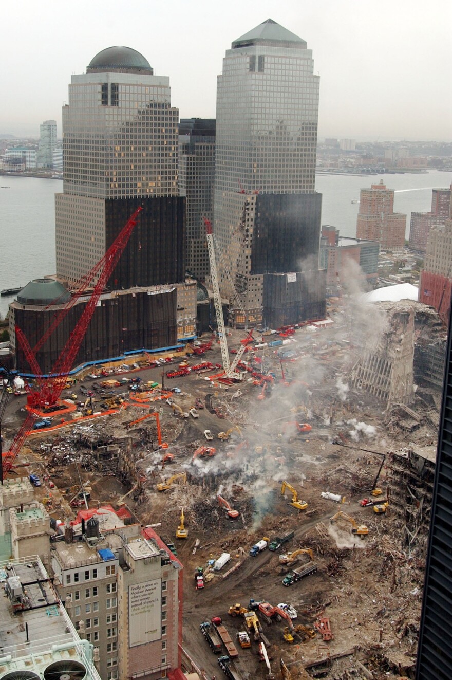 Smoke rises from the rubble as demolition continues at the remains of the World Trade Center in New York, Wednesday afternoon Oct. 31, 2001. In background is the World Financial Center.