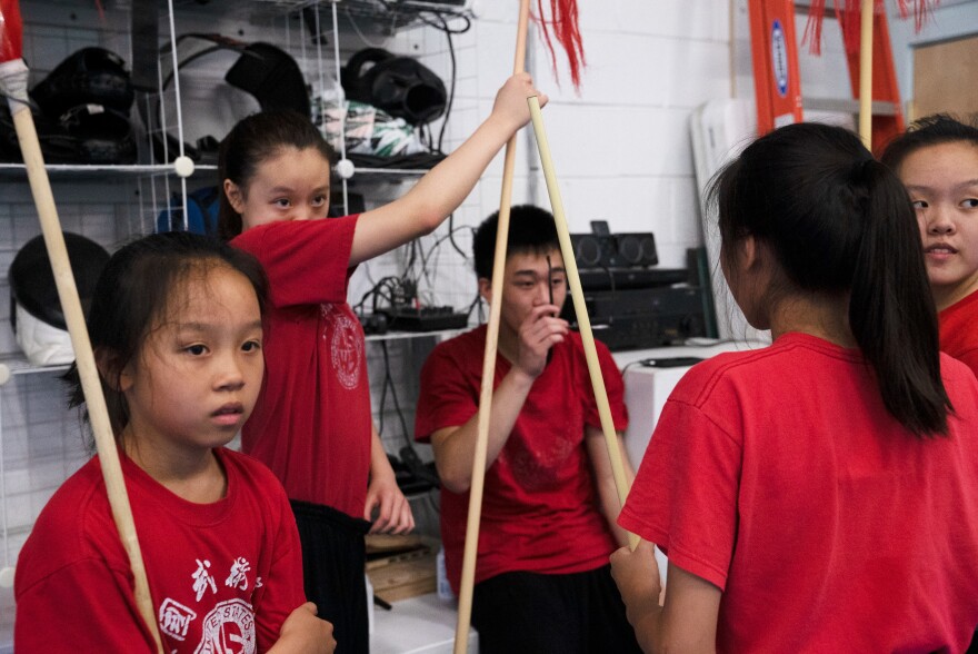 The advanced team, Jocelyn Gu, 12, Michelle Xiong, 14, Benjamin Tran, 15, Joanne Li, 13, Helen Gu, 16, listens to feedback from Zhang.