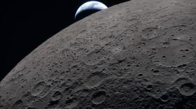 In this image provided by NASA, the Artemis II crew captured this view as the Earth sets behind the Moon during a lunar flyby, Monday, April 6, 2026. (NASA via AP)