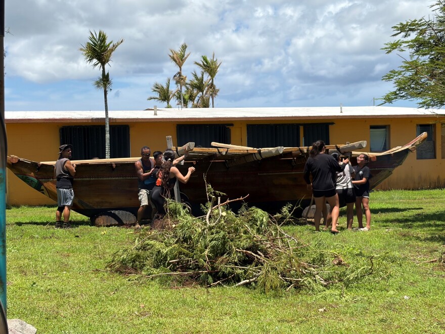 A large canoe is hoisted by a crew in Tumon Bay on Guam after destructive winds impacted the island during Super Typhoon Bavi. (July 18, 2026)