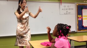 Instructor Huiling Li encourages second-grader Trinity Faulkner on the first day of Mandarin Chinese classes at Brookdale Elementary School in Macon, Ga.