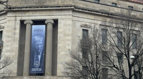 A banner showing President Donald Trump hangs on the Department of Justice on Feb. 20, 2026. The U.S. Court of Appeals in the 10th Circuit issued a 2-1 decision regarding fate of an Iranian immigrant who was arrested soon after moving to Kansas in 2025.