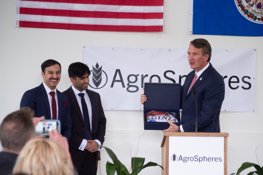 AgroSphere Co-founders (from left) Payam Pourtaheri and Ameer Shakeel receive a Virginia flag from Gov. Glenn Youngkin.