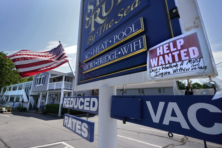 A "help wanted" sign is taped to a sign outside a motel Wednesday, May 26, 2021, in Wells, Maine.