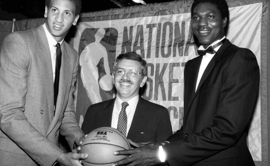 NBA commissioner David Stern is flanked by Akeem Olajuwon (right), the No. 1 pick overall by the Houston Rockets, and Sam Bowie, the No. 2 pick overall by the Portland Trail Blazers, at the NBA Draft in New York on June 19, 1984.
