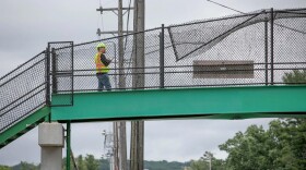 Michigan Department of Transportation Bridge Inspector Erik Snyder inspects the pedestrian bridge, which was struck by an excavator towed by a truck on U.S. 31 Thursday morning in East Bay Township. Snyder said the bridge, which previously had been scheduled for a routine inspection Thursday, then also needed a high-load hit inspection after the incident.