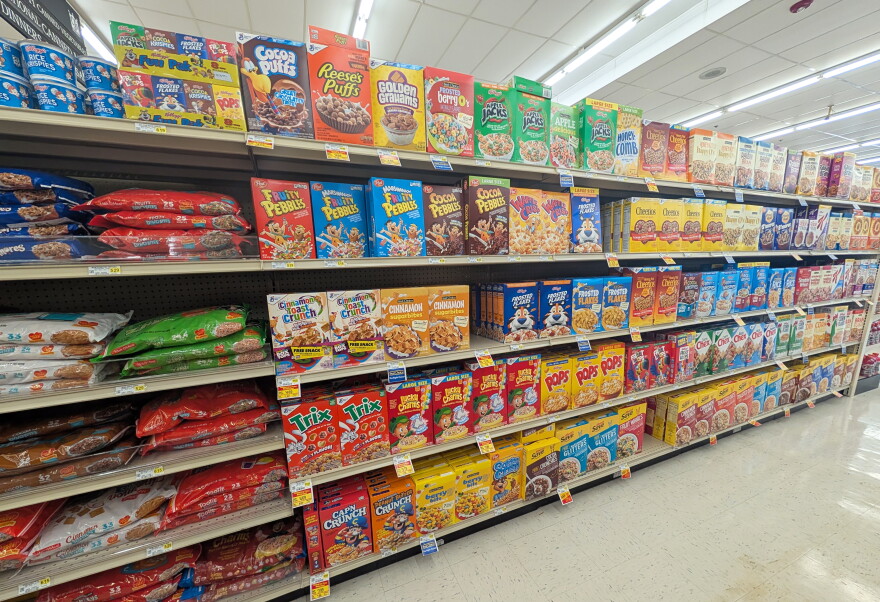 The cereal aisle of a grocery store, with name-brand and store-brand options.