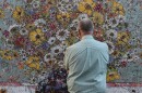 A festivalgoer looks at a piece of art at the 2026 Kimball Arts Festival.