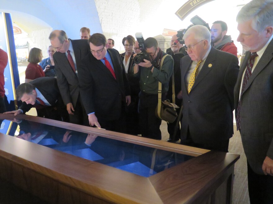 Former Gov. Bob Taft (R, maroon tie), Senate President Larry Obhof (R-Medina, red tie), former Senate President Richard Finan (R-Cincinnati, yellow tie) and former Senate President Tom Niehaus (R-New Richmond) look at the display.