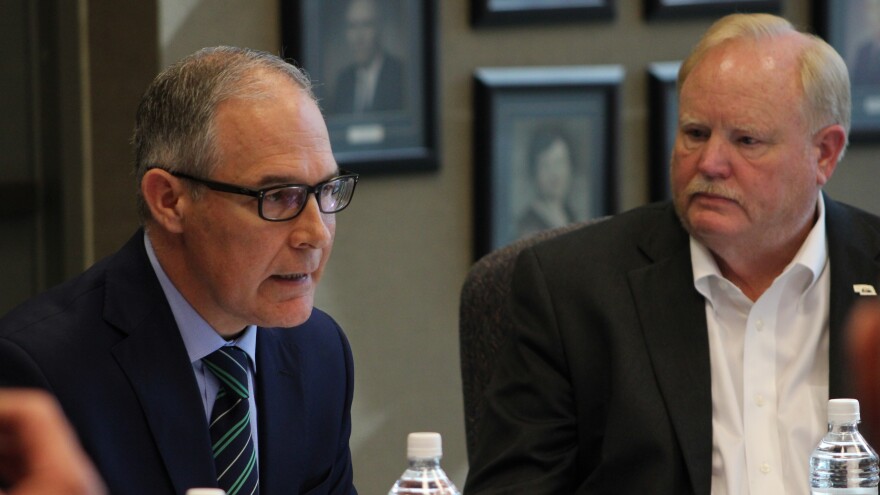 Steve Nelson (right), president of the Nebraska Farm Bureau, looks on as Scott Pruitt talks to farmers in Lincoln, Neb.