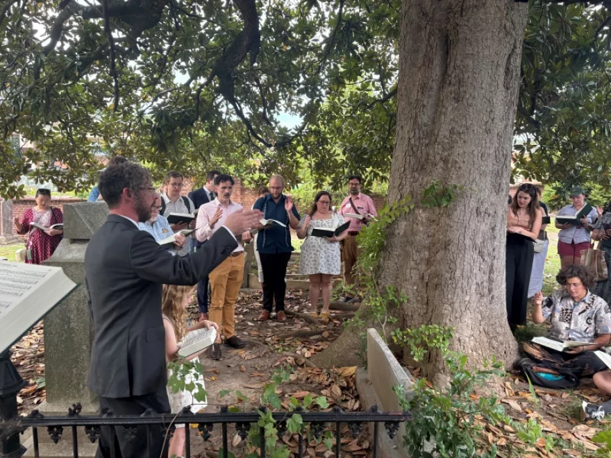Jesse Karlsberg leads a Sacred Harp tune at the grave of Benjamin Franklin White, who compiled the original 1844 edition of The Sacred Harp, at Atlanta's historic Oakland Cemetery.