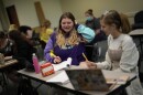Students Camryn Robinson, left, and Adeline Harrell work together on an in-class project in their "Rhetoric of Walt Disney World" class at New College of Florida, Thursday, March 2, 2023, in Sarasota, Fla. The academic freedom that allows students to design individualized majors is mirrored by a student body that feels free to express itself, say students and faculty, who describe New College as a haven for brainy kids who are high-achieving and intellectually curious. (AP Photo/Rebecca Blackwell)