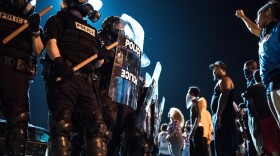 Police officers face off with protesters on the I-85 during protests following the death of a black man, 43-year-old Keith Lamont Scott, shot by a black police officer on Sept. 21, 2016 in Charlotte, N.C. (Sean Rayford/Getty Images)