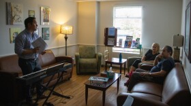 Music therapist Ryan Tonkin speaks with attendees Jennifer Paster and Bruce Paster during a music and stress management class.