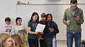 Teacher Donnie Piercey, right, works with students as they perform a three-scene play written by ChatGPT during his class at Stonewall Elementary in Lexington, Ky., Monday, Feb. 6, 2023. Parameters of the play were entered into the ChatGPT site, along with instructions to set the scenes inside of a fifth-grade classroom. Line-by-line, it generated fully-formed scripts, which the students edited, briefly rehearsed and then performed. (AP Photo/Timothy D. Easley)