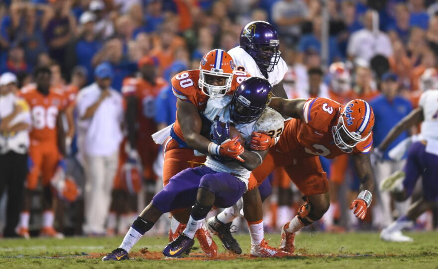 Florida defensive lineman Jonathan Bullard (90) wraps up East Carolina running back Chris Hairston (22).