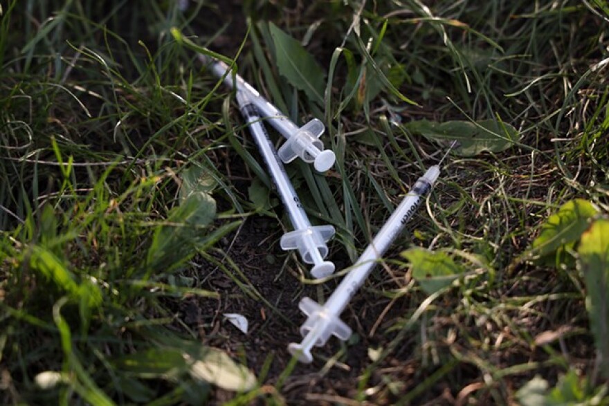 Used needles litter the ground of the Loomis Street homeless encampment.