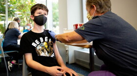 Lisa Heithhaus, a staff registered nurse, administers the COVID-19 vaccine to Ben Meyerkord, 11, of Crestwood, on Tuesday, Nov. 9, 2021, at St. Louis Children’s Hospital. The federal government recently approved vaccinations for children from 5 to 12 years-of-age. 