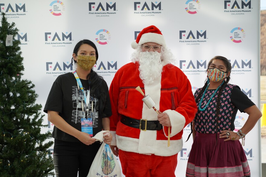 Indigenous Santa poses with two attendees of the First Americans Museum 2021 Winter Art Market. He's back for the 2023 event at FAM this weekend.
