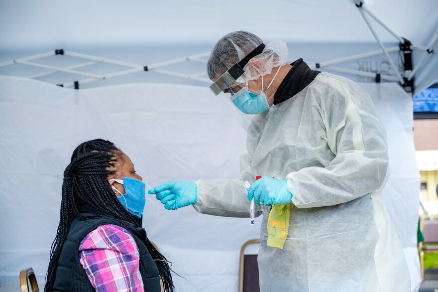  Monique Coleman receives a COVID-19 test in May 2020 at a mobile testing center in the North End of Hartford.