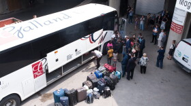 A bus of Haitian asylum seekers from the United States arrives at the Olympic Stadium in Montreal, Quebec, on Aug. 3, 2017. (Catherine Legault/AFP/Getty Images)