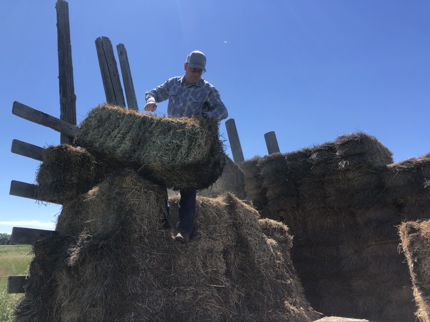 Marko Manoukian loads hay bales at his ranch near Malta. Manoukian is co-chair of the St. Mary’s Rehabilitation Working Group, which has been advocating for decades for repairs to the aging irrigation project.