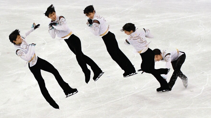 A multiple exposure image shows a portion of the free skate by Japan's Yuzuru Hanyu, the first man to repeat as Olympics figure skating champion since 1952.