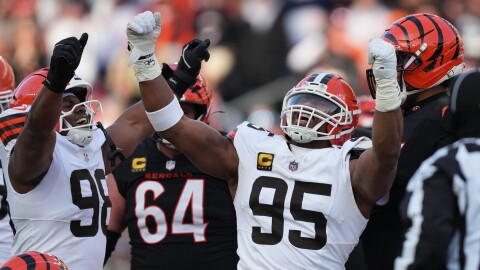 Cleveland Browns defensive end Myles Garrett (95) celebrates with defensive end Adin Huntington (98) after sacking Cincinnati Bengals quarterback Joe Burrow to set an NFL record for sacks in the regular season during the second half of an NFL football game, Sunday, Jan. 4, 2026, in Cincinnati.