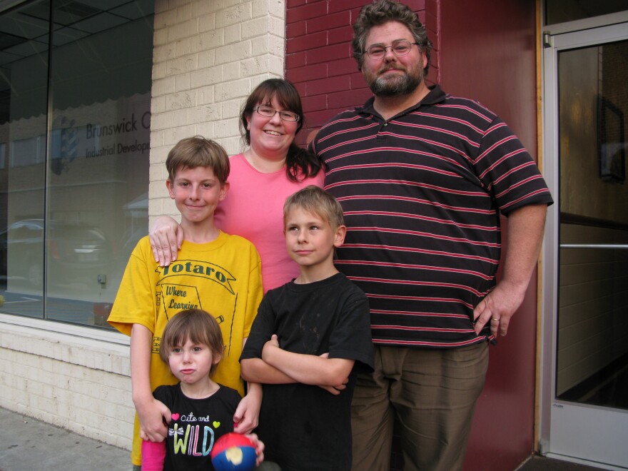 Emily and Derek Lewis and their children (from bottom left) Miranda, 3, Rhys, 10, and Alistair, 8. The Lewises live next to Saint Paul's College, and the notion of immigrant teens being housed there makes them uneasy.