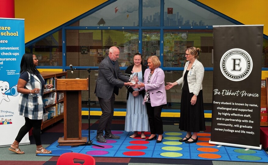 Smile America Partners CEO Steve Higginbotham presents the Children’s Health Champion Award to incoming Elkhart Community Schools Superintendent Michele Riise at Roosevelt STEAM Academy in Elkhart.