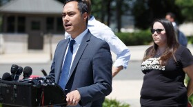 Congressman Joaquin Castro, D-San Antonio, speaks at a Washington rally, as RAICES Communications Director Jennifer K. Falcon looks on.