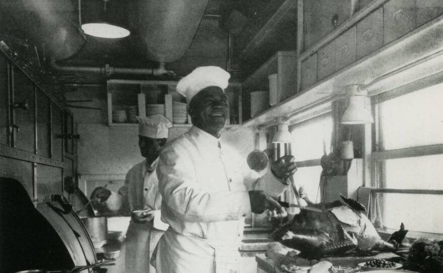 Railroad chef in narrow kitchen cutting turkey, undated.