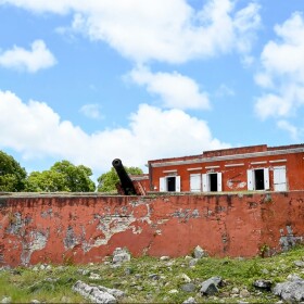 Pictured: A cannon leans on the back lawn of the Fort Frederik.