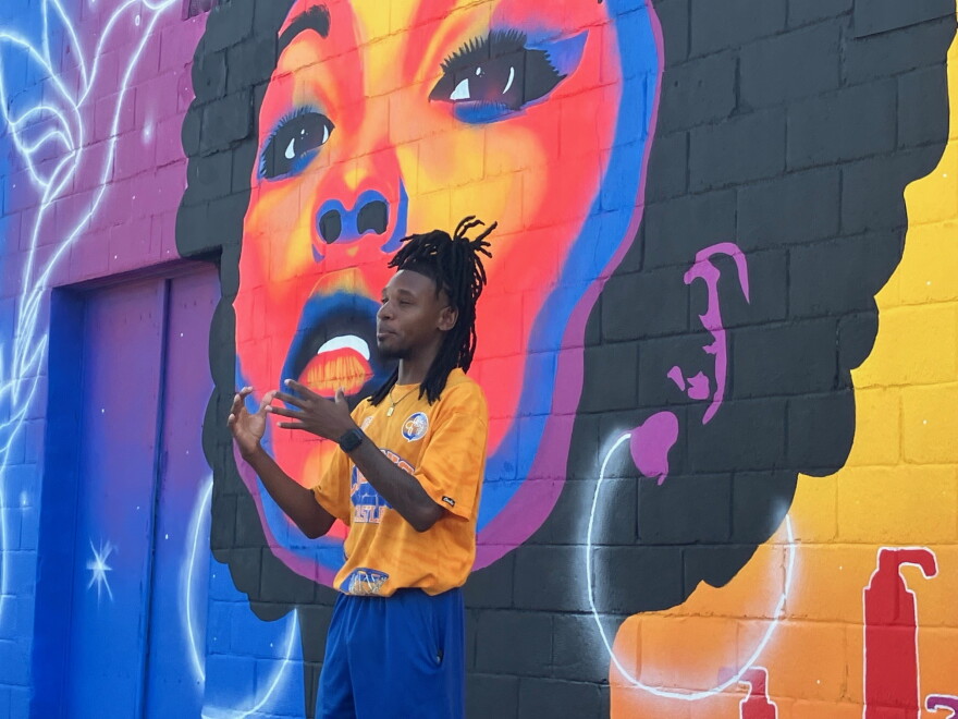 Zay Williams speaks at his new mural dedication in the parking lot at Celebrity's Beauty Supply, Sept. 4, 2026.